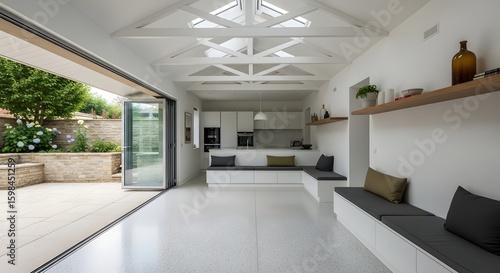 Bright Modern Open Plan Kitchen Living Space with Bi-Fold Doors to Patio, Vaulted Ceiling, and Natural Light. Contemporary Interior Design and Architecture in a Luxury Home