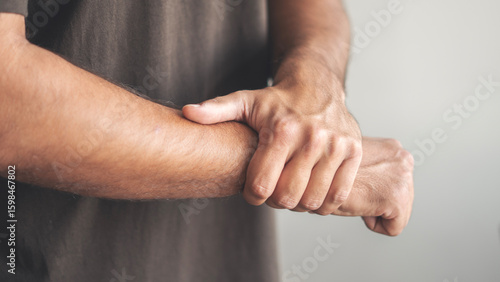 Rheumatism man hand pain from cramp, wrist pain touching massaging, hand holding ache joint