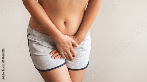 A woman holding her groin