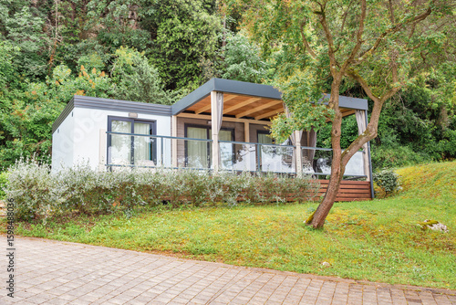 Premium mobile home with glass terrace in forest.