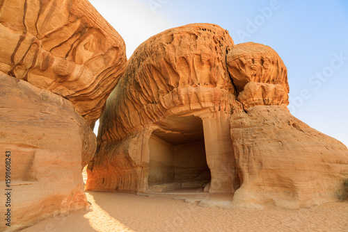 Εκτύπωση καμβά Sunlight illuminating Jabal Ithlib carved facades of ancient Nabataean tombs at