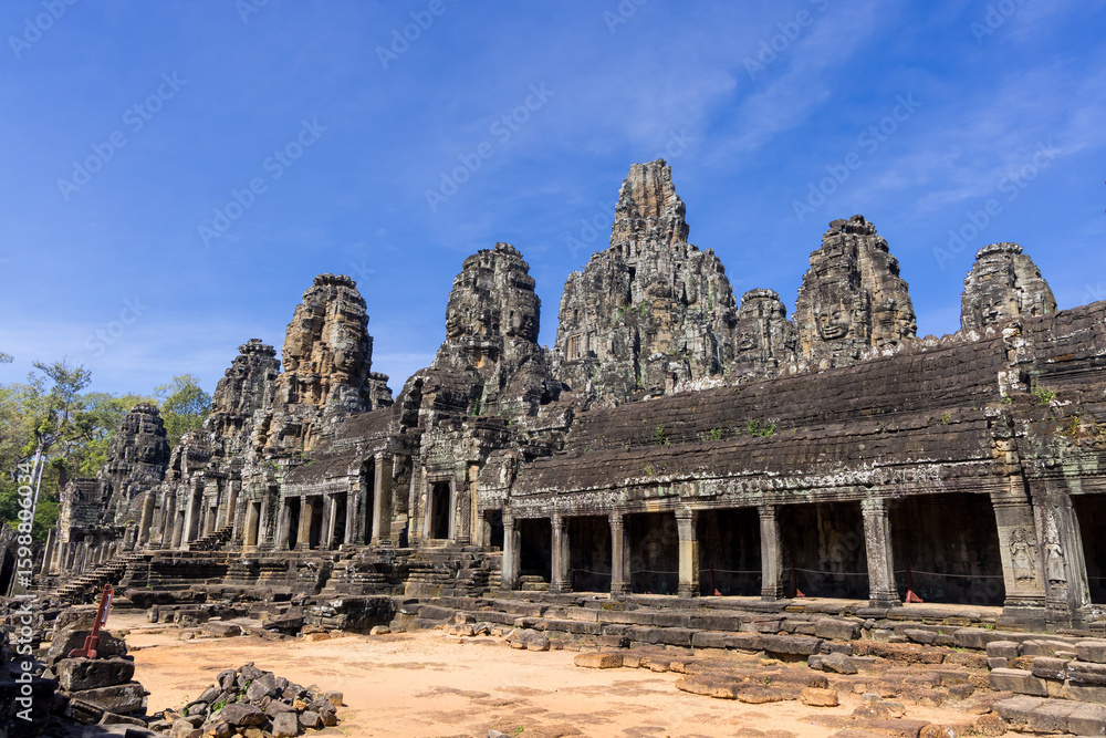 Ruins of historic Bayon Temple in Angkor Thom, Siem Reap, Cambodia during sunny day. Ruins of historic Bayon Temple in Angkor Thom, Siem Reap, Cambodia during sunny day.