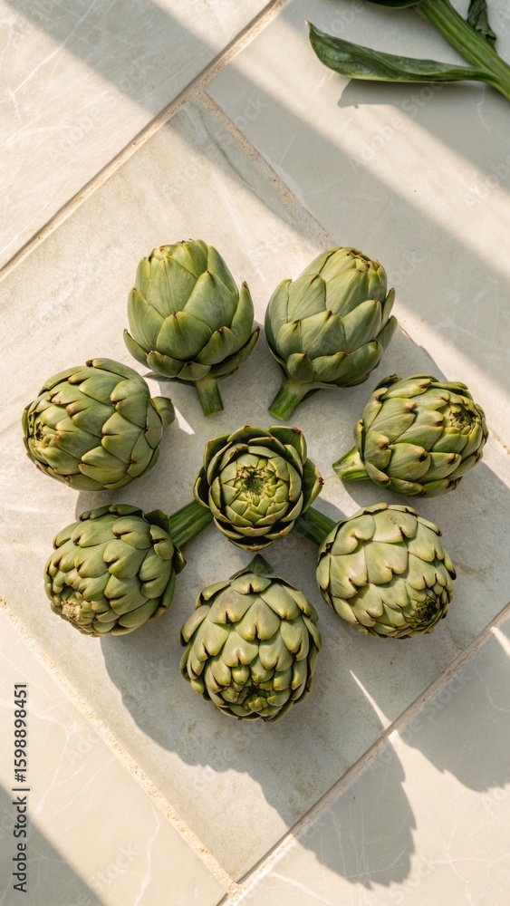 Fototapeta premium Geometric arrangement of globe artichokes flat lay - stock photo