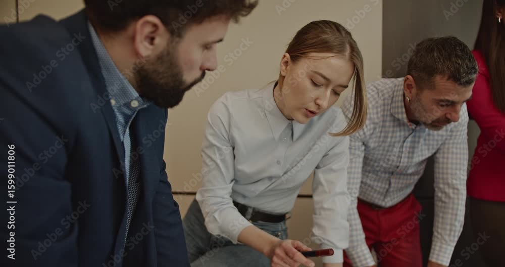 A multinational business team collaborates on a project, analyzing charts and discussing strategies in a modern office environment. A multinational business team collaborates on a project, analyzing charts and discussing strategies in a modern office environment.