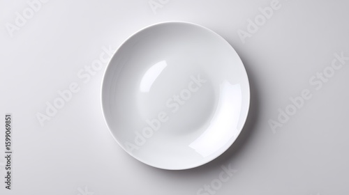 Empty white plate on a neutral grey background, minimalist culinary canvas for food photography and design inspiration
