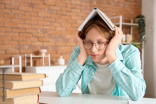 Tired male student in eyegl...
