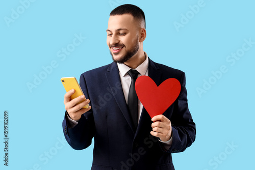 Young man with heart and ph...