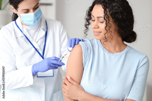 Female doctor vaccinating A...