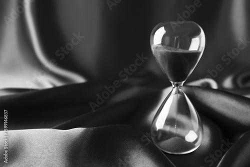 Crystal hourglass on dark  ...