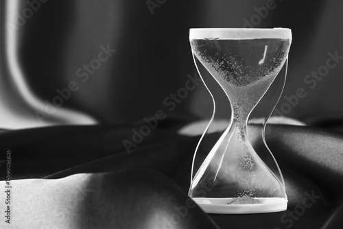 Crystal hourglass on dark  ...