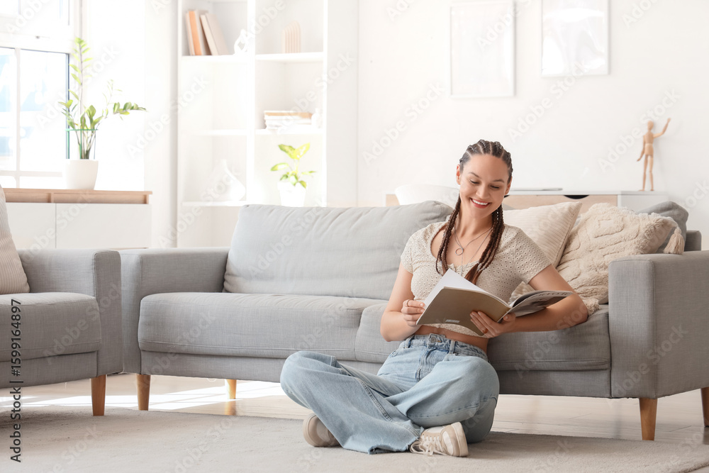 Young woman with dreadlocks reading magazine at home Young woman with dreadlocks reading magazine at home