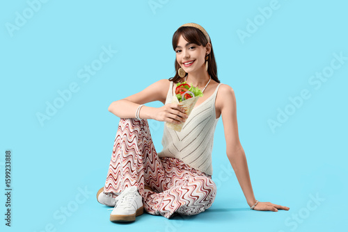 Young woman with tasty sand...