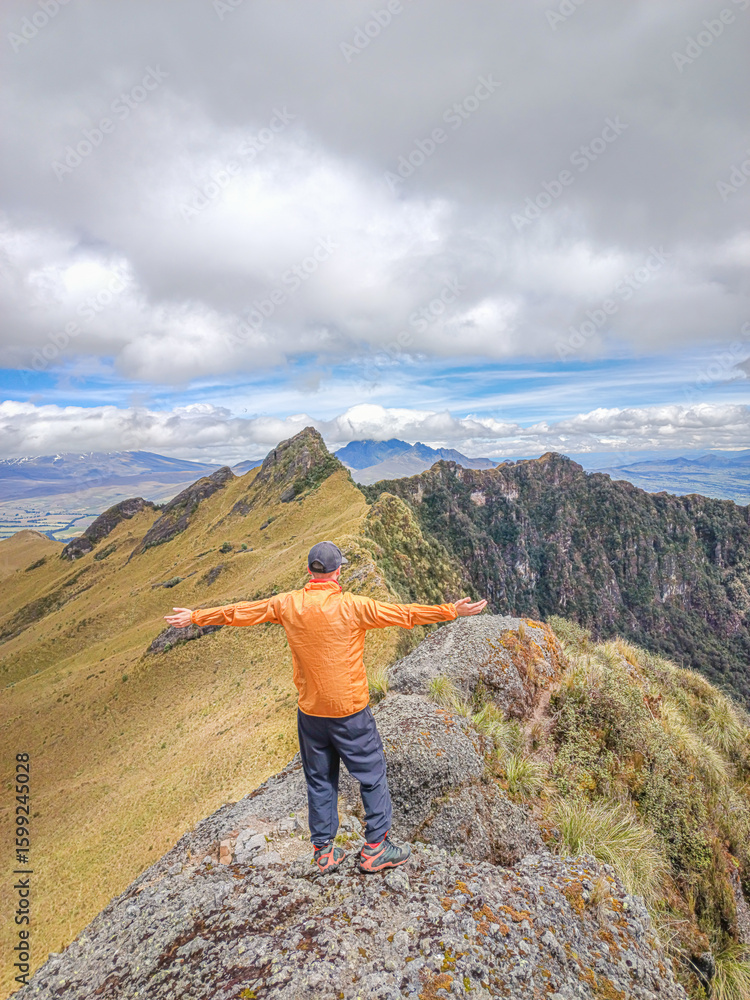 Fototapeta premium Pichincha Province, Quito, Ecuador - July 5, 2025: Tourist at the summit of Pasochoa Volcano, located in the Pasochoa Wildlife Refuge. The extinct volcano is 4,200 meters high.