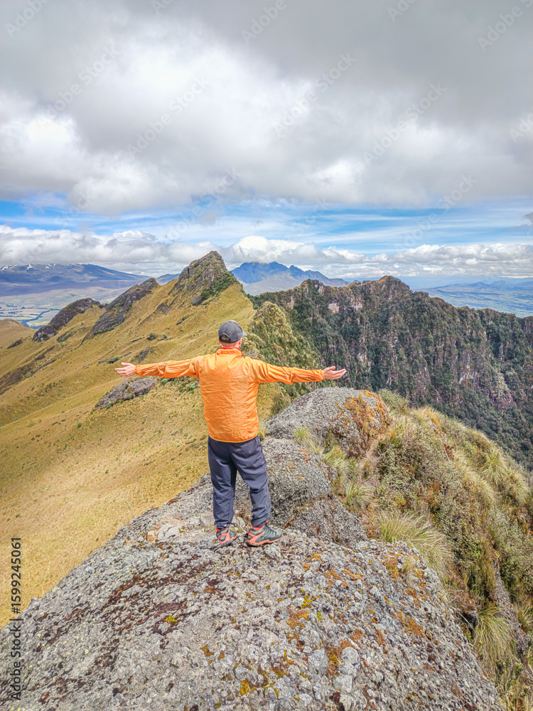 Naklejka premium Pichincha Province, Quito, Ecuador - July 5, 2025: Tourist at the summit of Pasochoa Volcano, located in the Pasochoa Wildlife Refuge. The extinct volcano is 4,200 meters high.