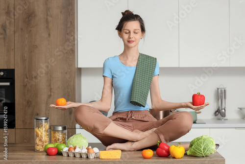 Young housewife meditating ...