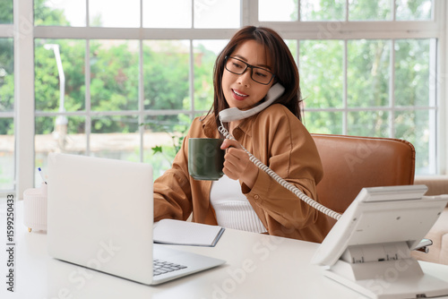 Young Asian woman with cup ...