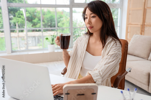 Young Asian woman with cup ...