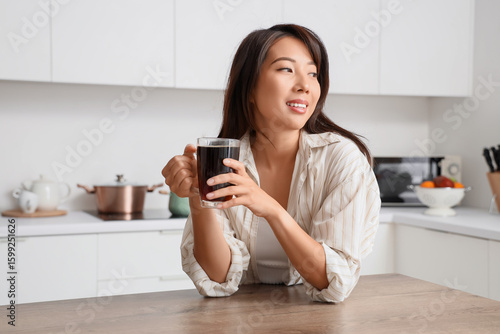 Young Asian woman with cup ...
