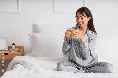 Young Asian woman with cup ...