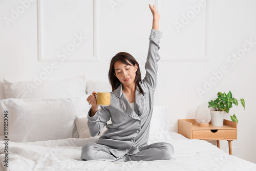 Young Asian woman with cup ...