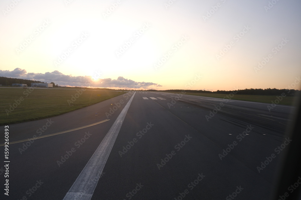 Fototapeta premium Taxiing on the runway at Dawn in New England, the tarmac stretches, anticipation builds