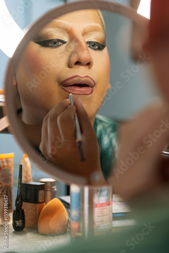 A drag queen putting on her makeup before going out to perform at a local theater in Peru.