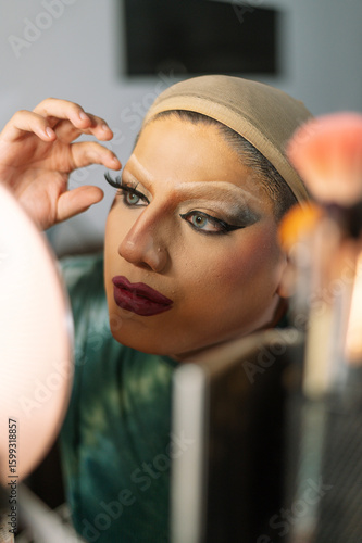 A drag queen putting on her makeup before going out to perform at a local theater in Peru.