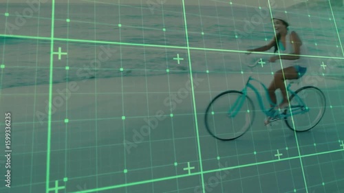Tech grid overlay sweeping across beach starting scan, woman pedaling turquoise bike leisurely