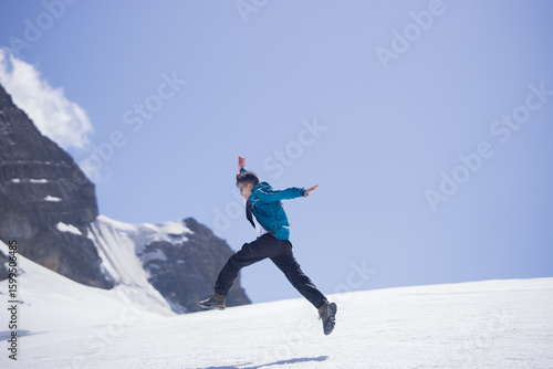 Man jumping high on snowy mountain in Peru