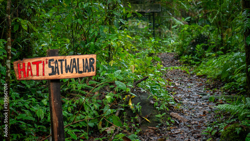 Canvas Print Warning Sign in Tropical Forest Trail: HATI² SATWA LIAR (Beware of Wild Animal