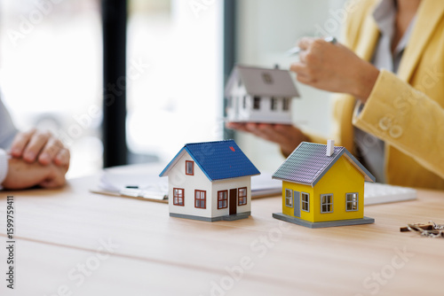 Tableau sur toile House model over the Sale representative offer the price list and condition for purchase or rental on the working space table in new place,sign contract Moving and House Hunting concept