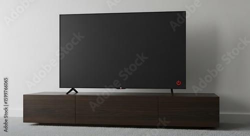 Modern flat screen television atop a sleek wood console, minimalist design