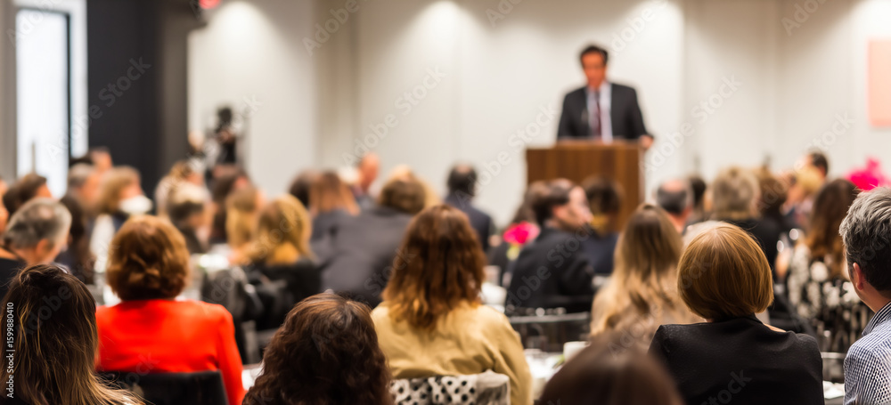 Obraz premium educational symposium with audience listening to speaker, academic atmosphere