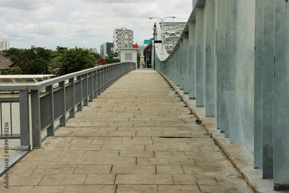 Fototapeta premium Pedestrian view of Krungthep Bridge, Chao Phraya river crossing truss bridge in Bangkok