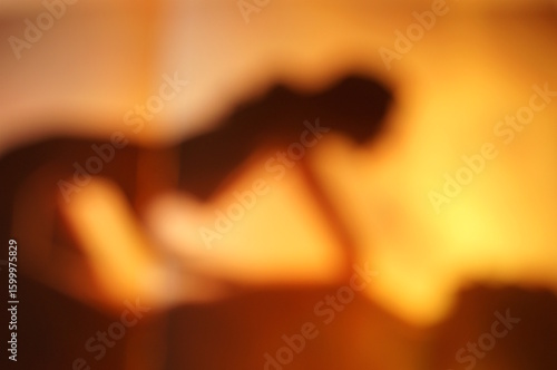 Wallpaper Mural Silhouettes of a man and a woman making love. Blurred abstract background. An orange shade. Torontodigital.ca