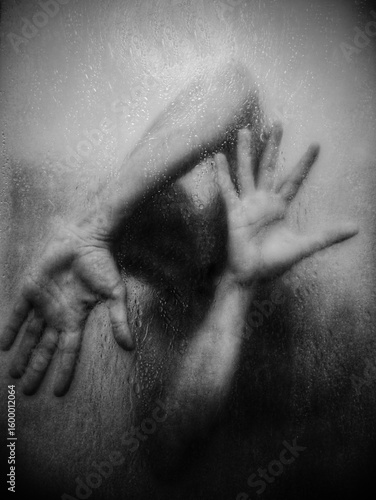 Silhouette behind foggy glass, hands pressed, emotional tension.