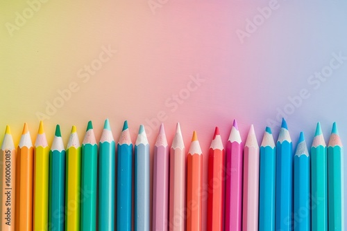 Charming pastel workspace flatlay featuring vibrant pencils and stylish notebooks for inspiration