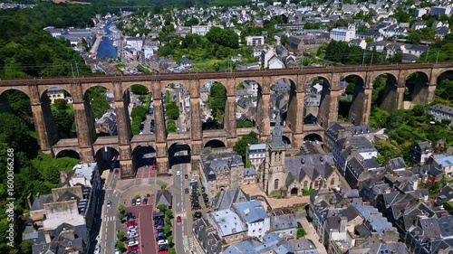 The drone pulls back above the rooftops, revealing Saint-Melaine Church, the Morlaix Viaduct, and the city surrounding them. Brittany in France