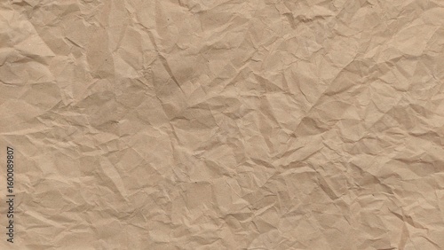 Crumpled old rough brown paper background with natural folds and creases. Crumpled old brown vintage paper surface texture for background. Crumpled brown recycle paper texture.