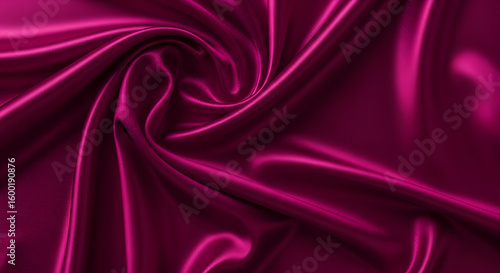 Close up of a luxurious magenta satin fabric with soft folds and subtle light reflections creating depth