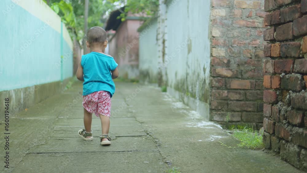 A child is having fun playing alone on the street. A child is having fun playing alone on the street.