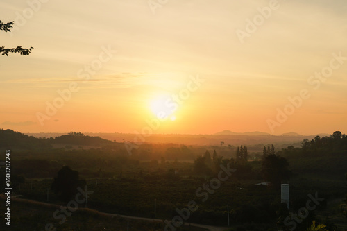 Sunrise in Khao Yai, Thailand. Majestic sunrise over the mountains. Colorfull sunrise on foggy day over Tipperary mountains and fields. Beautiful sunshine at misty morning mountains.
