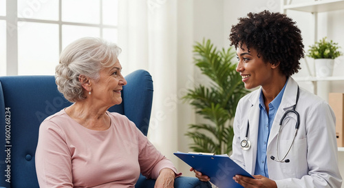 Female doctor visiting elderly woman at home for medical checkup