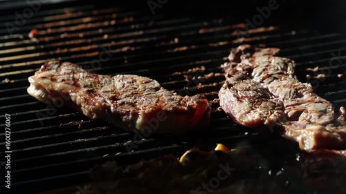Cooking beef steak Juicy gill steak sizzling on an open flame grill with smoke