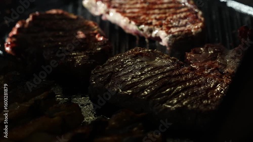 Cooking beef steak Juicy gill steak sizzling on an open flame grill with smoke