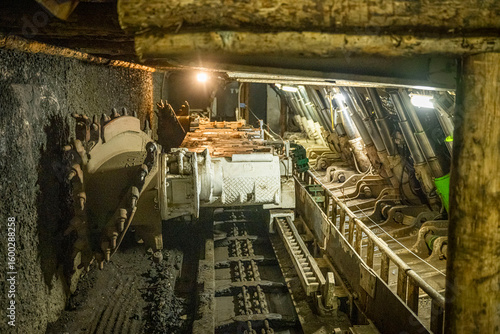Longwall face with a shearer, scraper conveyor, and powered roof supports