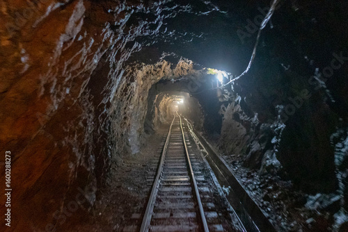 Coal mine corridor with tracks, trolley and lighting