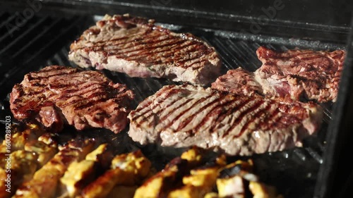 Cooking beef steak Juicy gill steak sizzling on an open flame grill with smoke