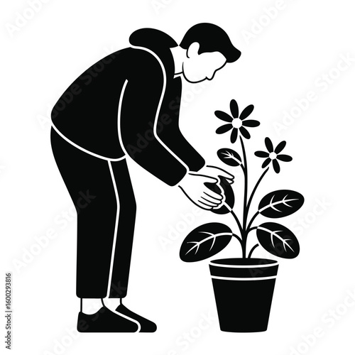 Person tending to a potted plant with flowers