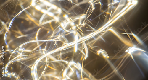 Abstract close up of light strands with bokeh effect and blurred motion in a dark environment